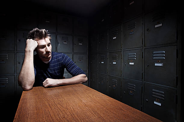 istock man sitting thinking in darken room 143921152