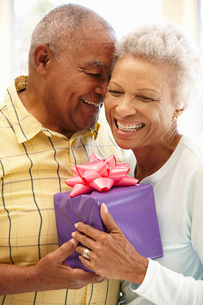 istock Senior man giving gift to wife 143921183
