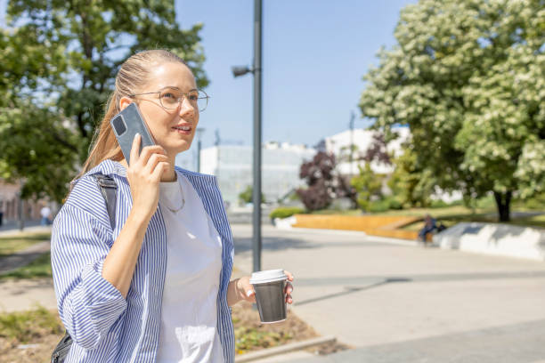 istock Young woman talking on phone when returning from college 1439212079