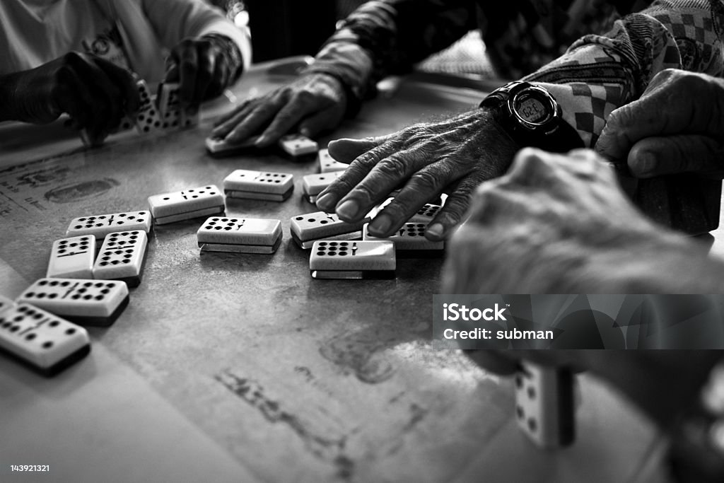 Hands playing dominos BW close-up image of hands playing dominos. Domino Stock Photo