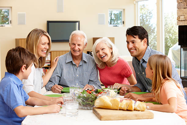istock Family talking and laughing while sharing meal 143921382