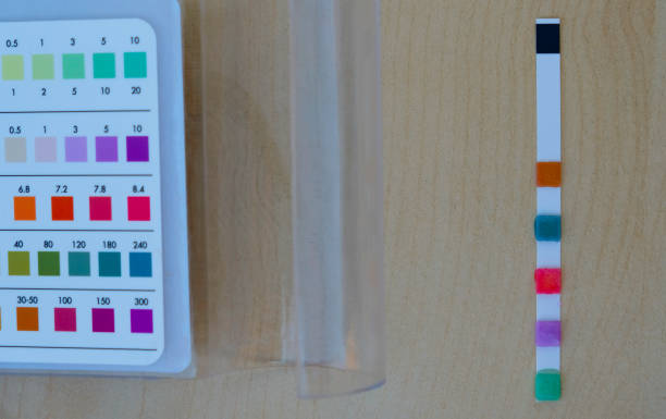 istock Pool test strip and a comparison chart on a wooden surface. Pool chemistry. 1439214486