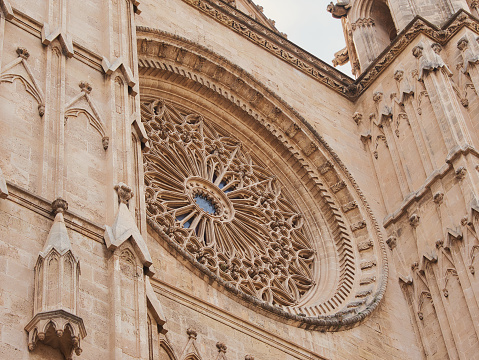 Part of the façade of the Cathedral of Santa Maria of Palma in the city of Palma, Mallorca, Spain. With round, ornamented window