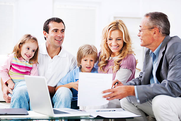 istock Young couple with children talking to financial advisor. 143921509