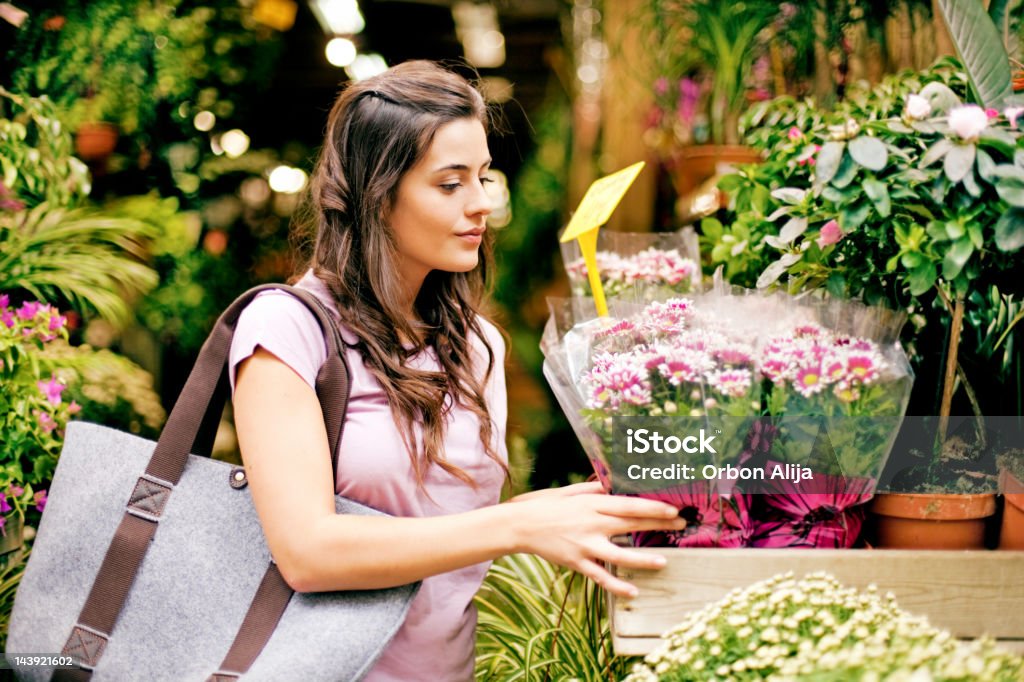 Young women buying flowers at market  20-24 Years Stock Photo