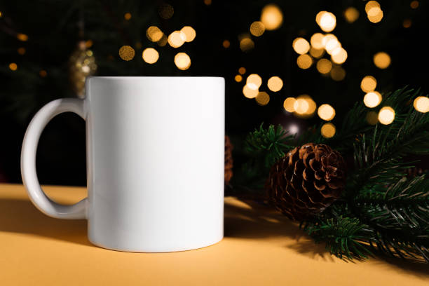 istock White ceramic mug with blank copy space for text and logo on a dark background with Christmas defocus lights. 1439218467