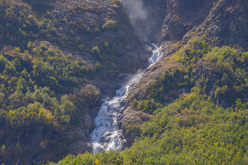 Tana glacier in North Ossetia, mountain waterfalls in the highlands