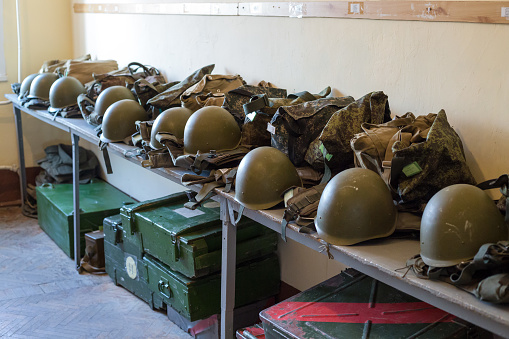 Helmet and combat kit in a bag for each soldier in the warehouse.