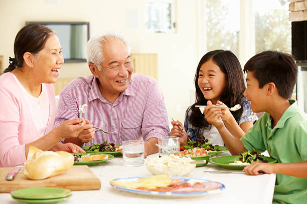 istock Asian family sharing meal at home 143921890