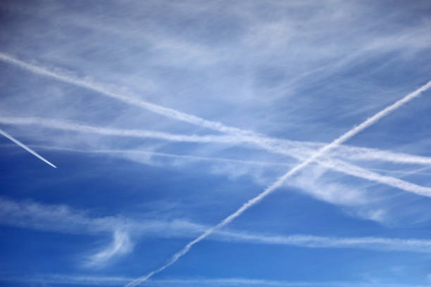 istock white trails and some clouds in the blue sky 1439218923