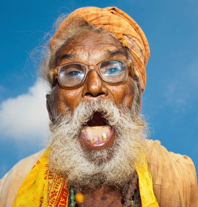 Smiling Indian bearded man wearing funky expressions white background. Man full of confidence.
