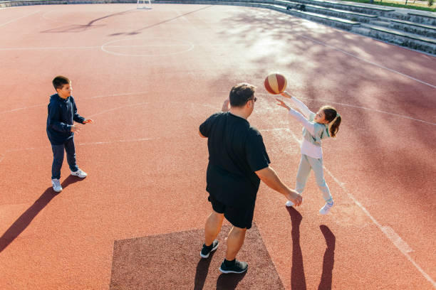 istock Father playing basketball with his children 1439220766