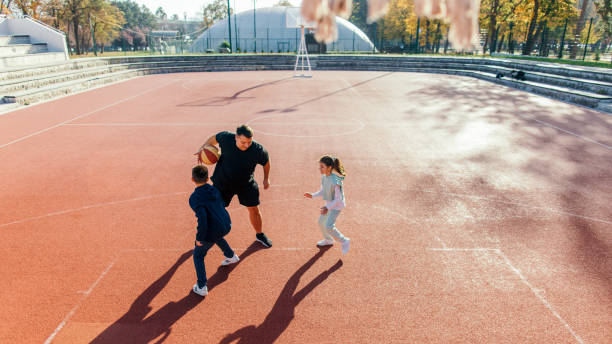 istock Father playing basketball with his children 1439220784