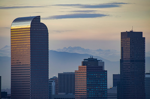 View of Denver Colorado Skyline at Sunset.  Looking at city with mountains in background.  Converted from 14-bit Raw file.  sRGB color space.