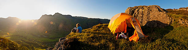 istock Idyllic summer camping child reading in mountains 143922209
