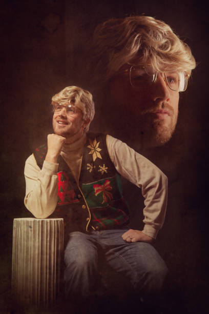 Emulated Vintage Christmas Portrait Photograph A man from the 1980s with glasses, highlighted hair, and a classy Christmas sweater vest poses for a picture on a fake marble pillar column.  Intentional 80's style kitsch post processing emulation.  Vertical. kitsch photos stock pictures, royalty-free photos & images