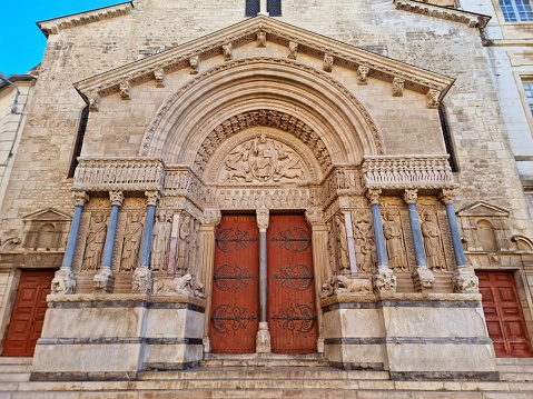 The Church of St. Trophime in Arles was built between the 12th century and the 15th century, and is in the Romanesque architectural tradition.  The image shows the main portal. Captured during autumn season.