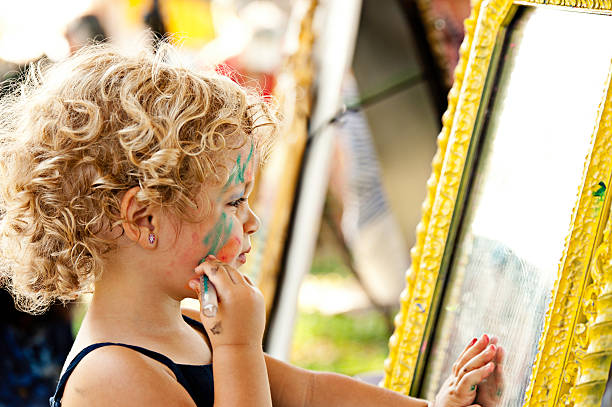Little boy with face painting crying.