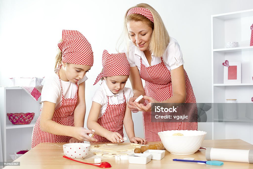 Madre e hijas hacen galletas - Foto de stock de 35-39 años libre de derechos
