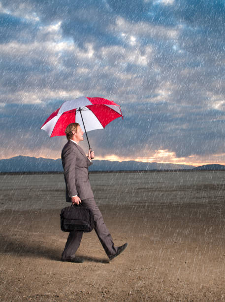 istock Businessman Walking in the Rain 143922506