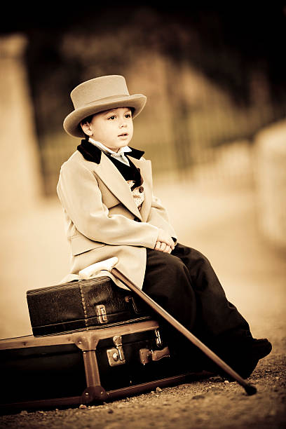 istock little boy in retro style waiting with old baggage 143922540