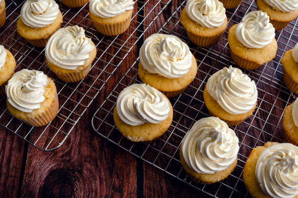 istock Homemade Vanilla Cupcakes on Wire Cooking Racks 1439226187