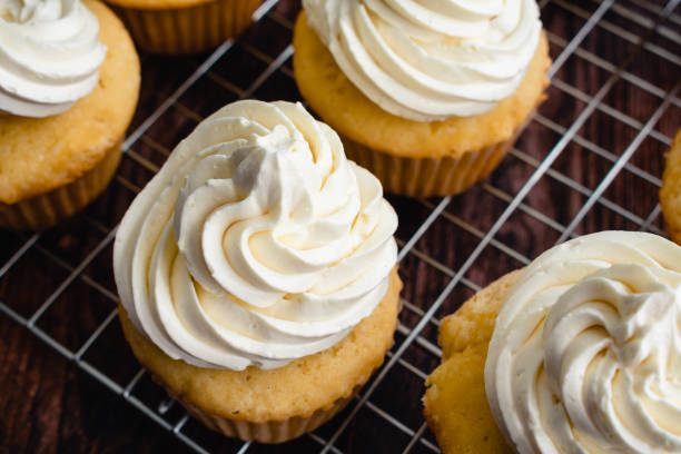 istock Homemade Vanilla Cupcakes on Wire Cooking Racks 1439226198