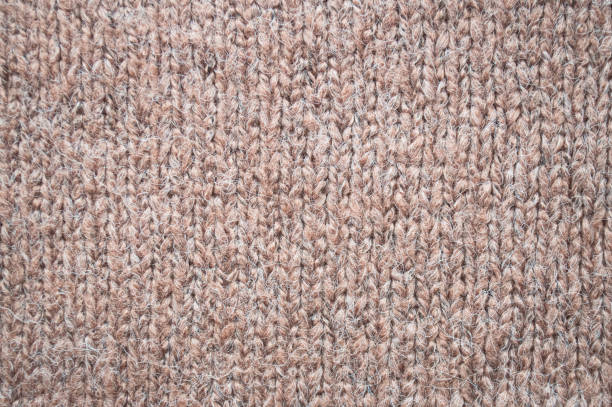 istock Handmade knitted material with detail woven threads. 1439226259