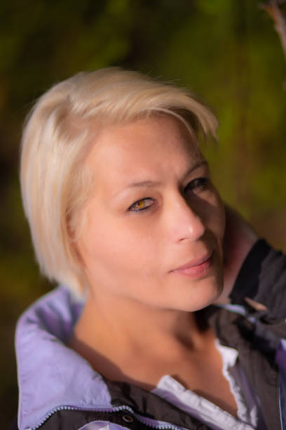 Blonde hair woman in city park