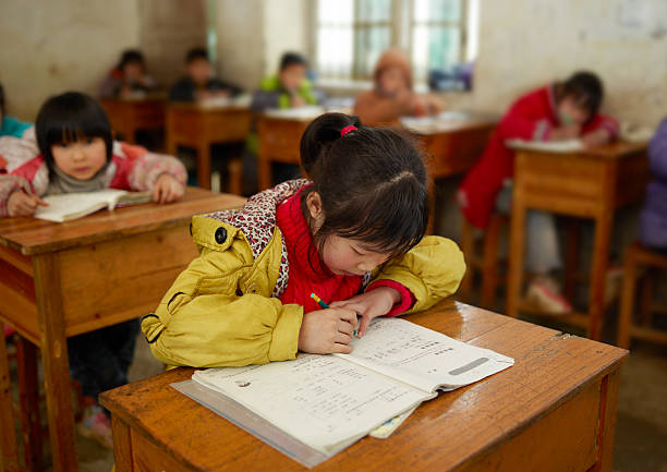 Chinese school children Chinese school girl writing in the classroom shinese exam stock pictures, royalty-free photos & images
