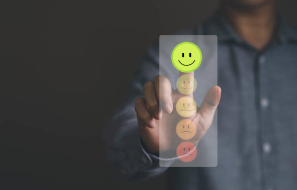 Person hand finger touching smile face for best score for customer review and good online feedback service. Person hand finger touching smile face for best score for customer review and good online feedback service. Customer or client rating quality feedback and satisfaction survey concept. satisfaction stock pictures, royalty-free photos & images