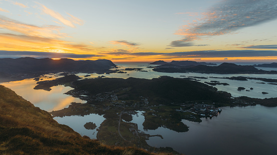 Scenic high-angle view of the autumn in the mountains with a view of the sea and the small islands during twilight in Ulsteinvik, More og Romsdal county