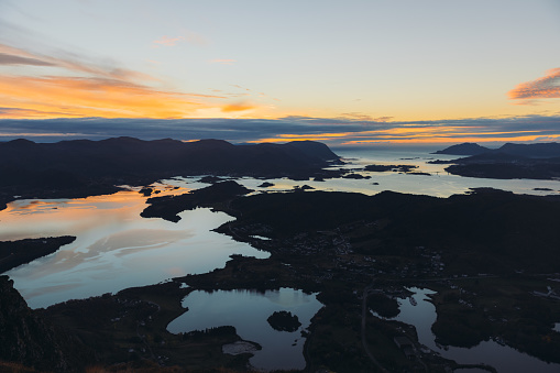Scenic high-angle landscape of the autumn in the mountains with a view of the sea and the small islands during twilight in Ulsteinvik, More og Romsdal county