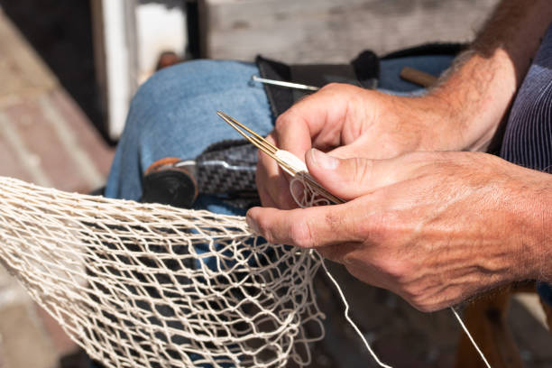 istock Repairing fishing nets 1439234918