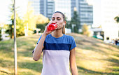 Sportswoman drinking water after workout.