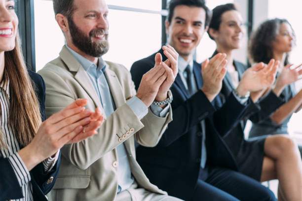 istock Businesspeople applauding during a seminar in conference hall. 1439235210