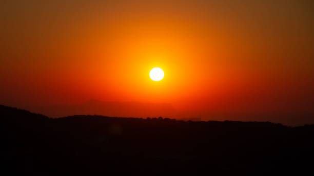 istock Dramatic sunset over the silhouettes of hills 1439236756