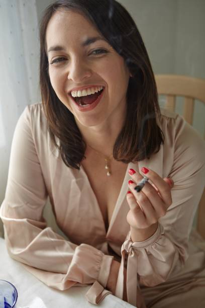 istock Stylish Woman Smoking a Joint at Home 1439237018
