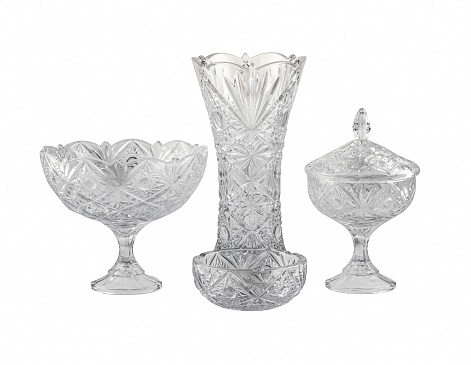 A closeup of vintage glass vases and bowls under the lights isolated on a white background