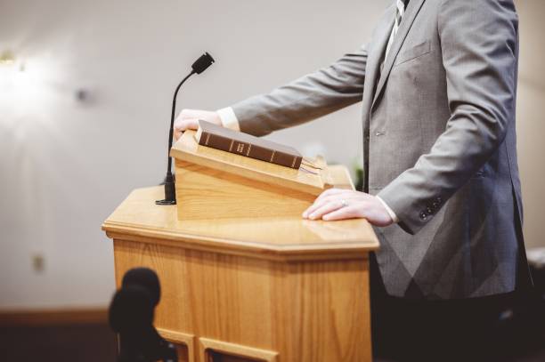 istock Selective focus shot of a male standing and speaking from the pulpit 1439240065