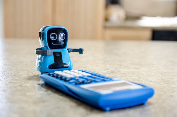 Generic toy robot using calculator stock photo