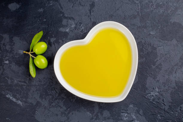 istock Green olive and olive oil isolated 1439244030