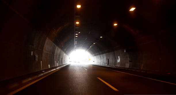 istock Dark tunnel on highway with the light in the end 1439245066