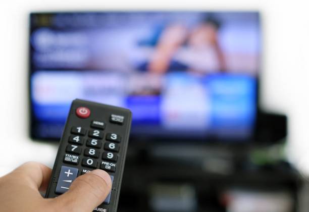 istock Remote control and screen - binge watching the favourite TV show 1439245193