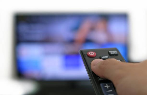 istock Remote control and screen - binge watching the favourite TV show 1439245303