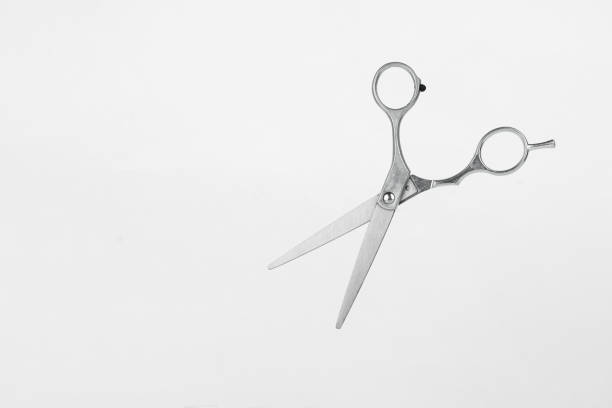 istock Open Silver Hair Cutting Scissors on White Background. Hairdresser tools. 1439245634