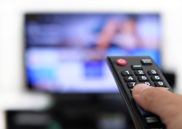 istock Remote control and screen - binge watching the favourite TV show 1439245666
