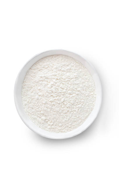 istock Bowl of white flour on white background. Top view 1439246041