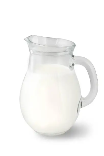 Glass jug of fresh milk isolated on white background. Milk food.