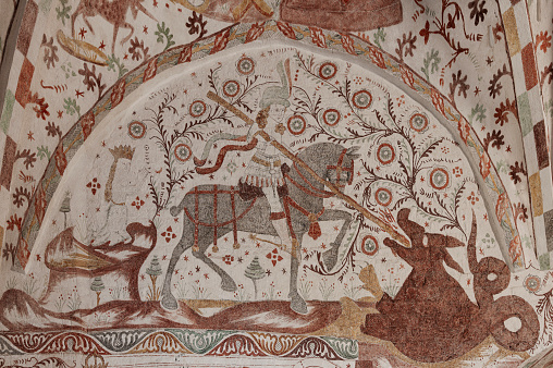 St. George kills the dragon and saves the princess, an old Wall-painting in Fanefjord church, Denmark, October 10, 2022